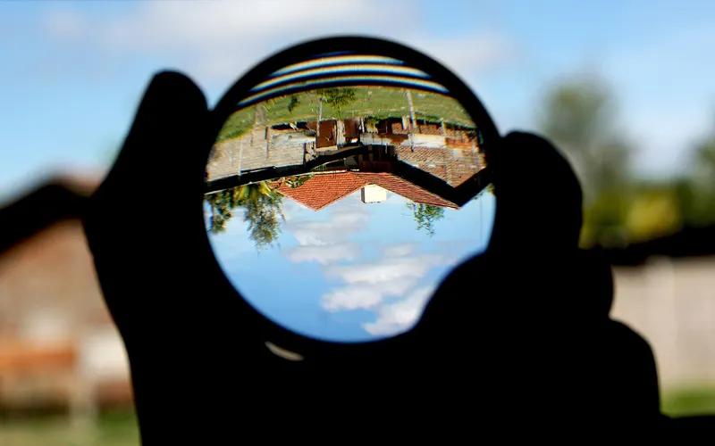 A magnifying glass showing a scene upside down