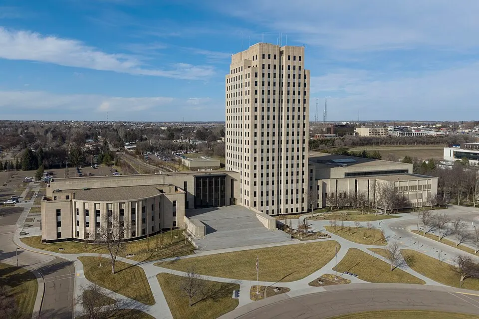 A tall slim skyscraper-style government tower on flat prairie.