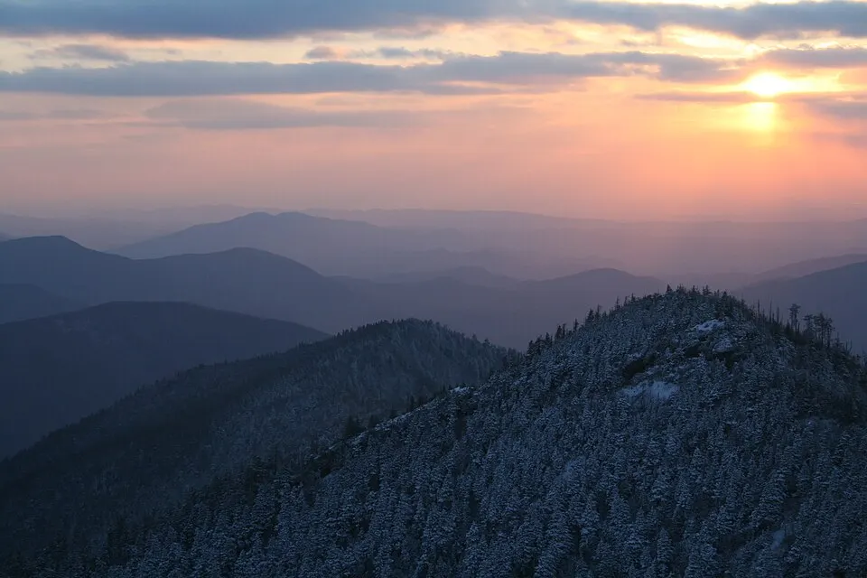 Blue misty forested mountain ridges fading into the distance.