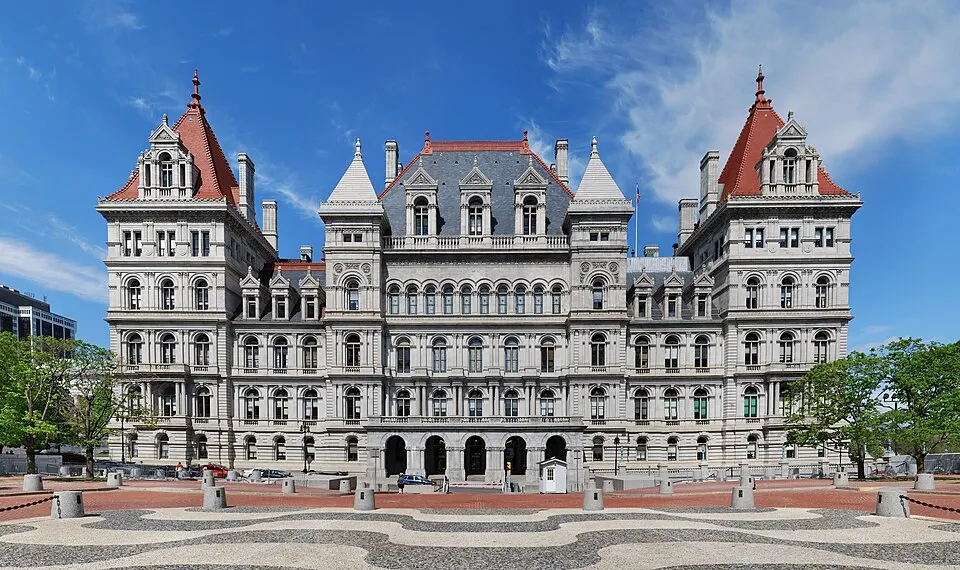 A grand granite castle-like government building on a hill.