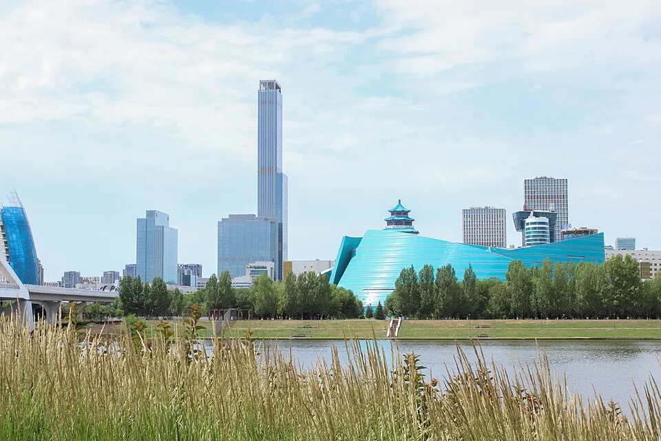 A riverside view of a modern city with tall buildings.