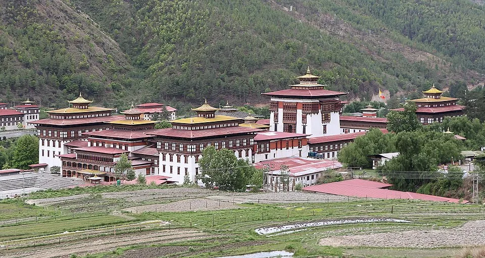 A traditional fortress-monastery with white walls and golden roofs.