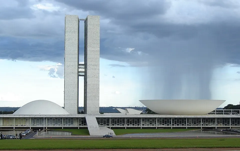 Two tall office towers between two white bowl-shaped domes.