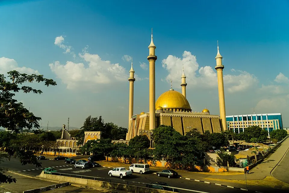 A large golden-domed mosque with tall minarets.
