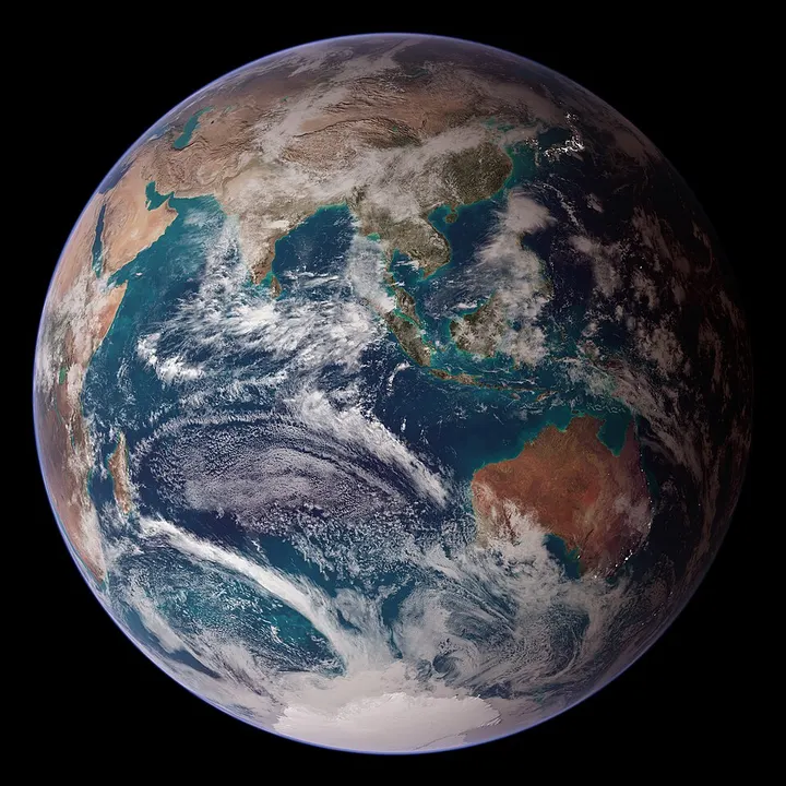 A view of Earth from space showing blue oceans, brown land masses and white clouds.