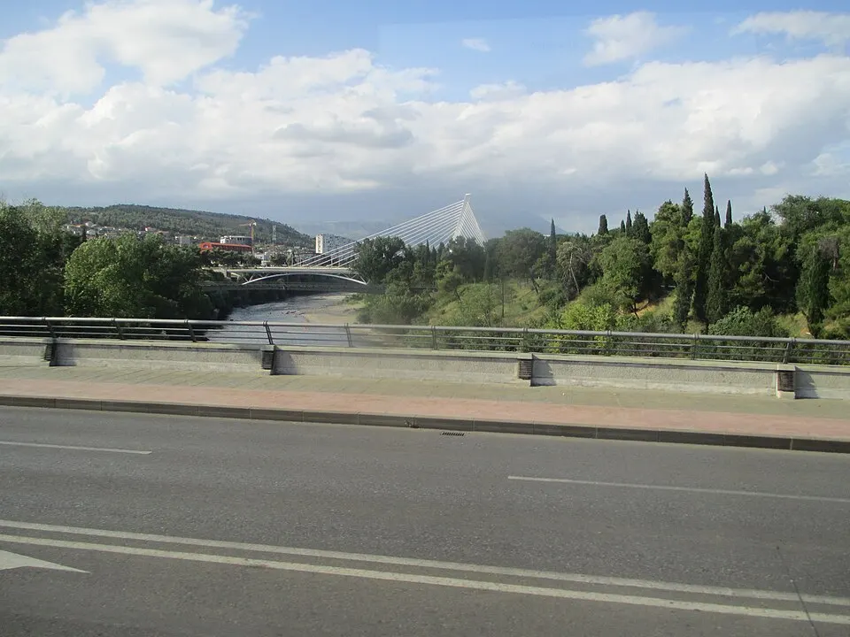 A modern cable-stayed bridge with a tall pylon over a river.