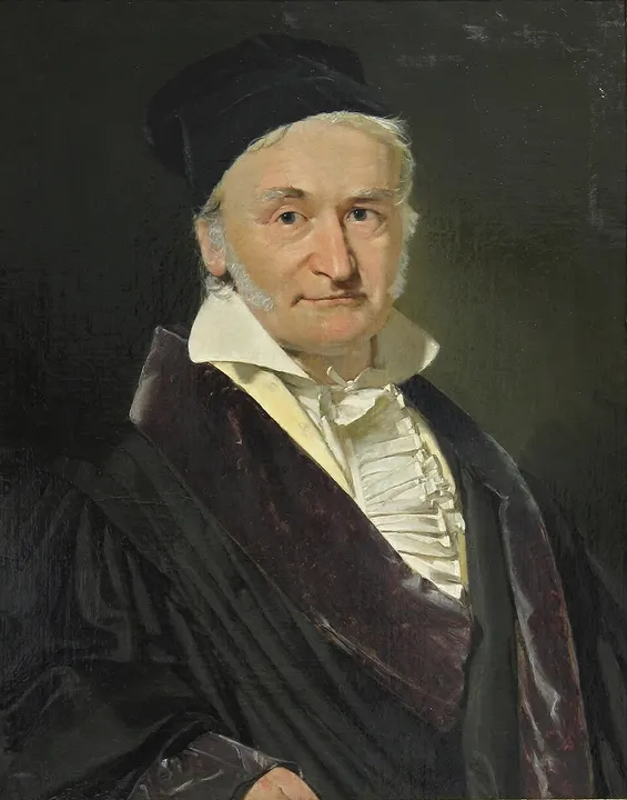 A portrait of an older man in a dark cap and coat.