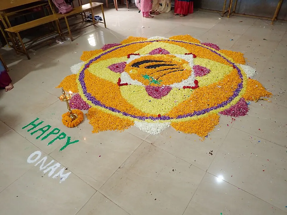 A large, intricate flower carpet laid out on a floor in concentric patterns.