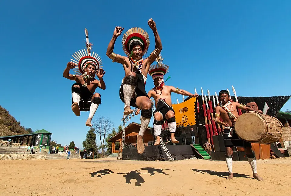 Tribal dancers in colourful beaded costumes and feathered headgear.