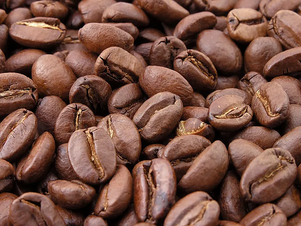 A heap of roasted brown coffee beans.