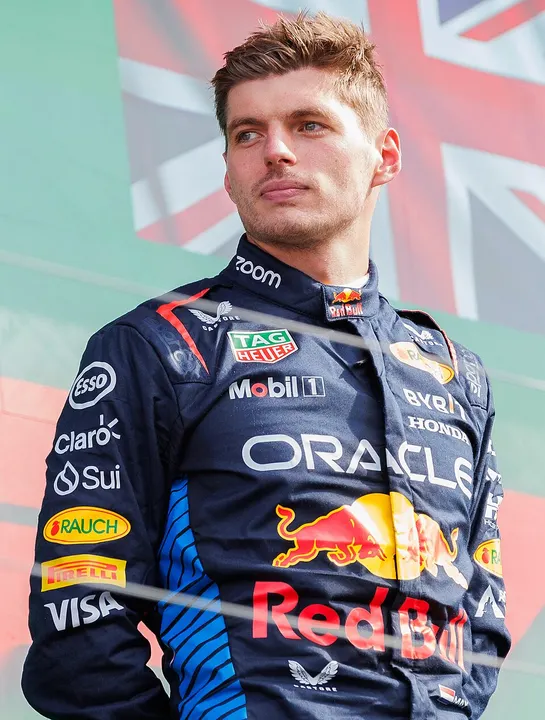 A young racing driver in team overalls.