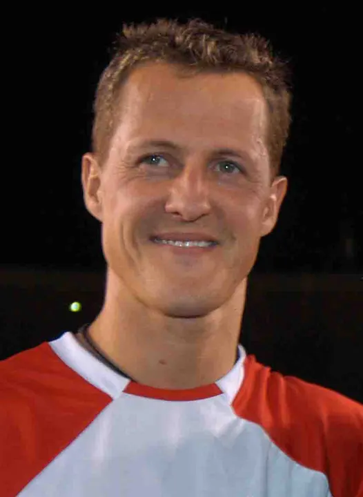 A smiling man in a red and white shirt.