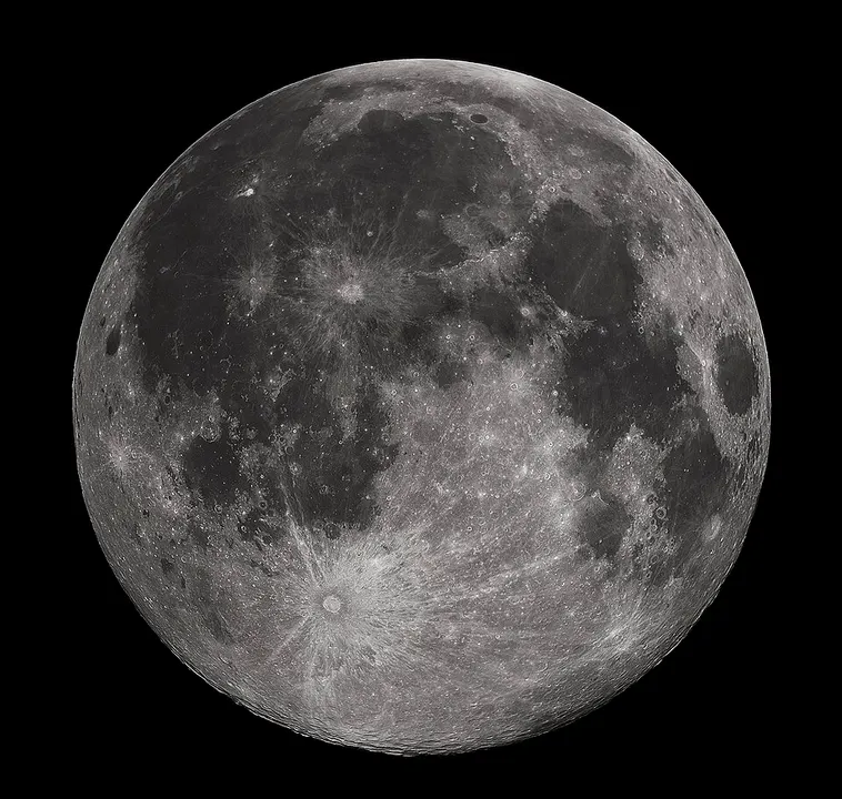A full moon in sharp detail, showing grey plains and bright craters on a black sky.