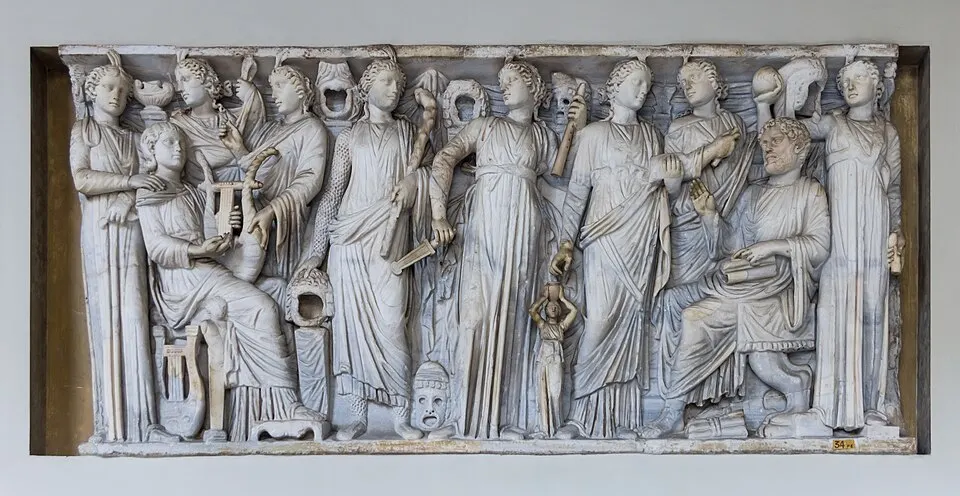 A marble relief of robed women holding lyres, scrolls and theatre masks, beside a seated bearded man.