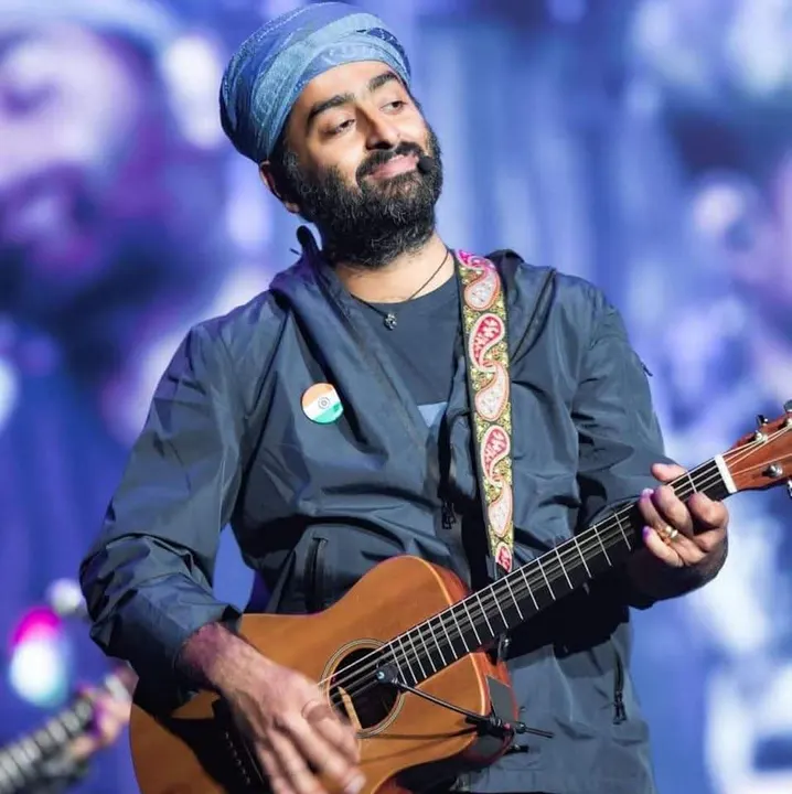 A man with a beard singing on stage.