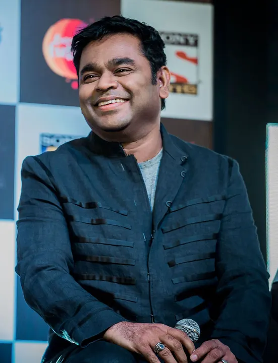 A man with long dark hair at a public event.
