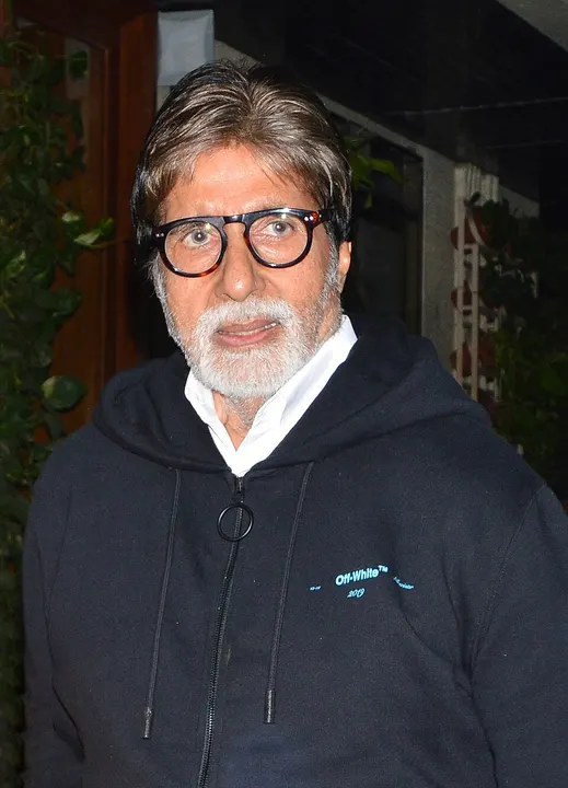A tall older man with grey hair and a beard at an event.