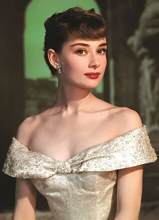 A black-and-white portrait of a slim woman with dark hair in an updo.