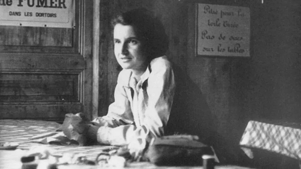 A black-and-white photograph of a woman with dark hair looking at the camera.