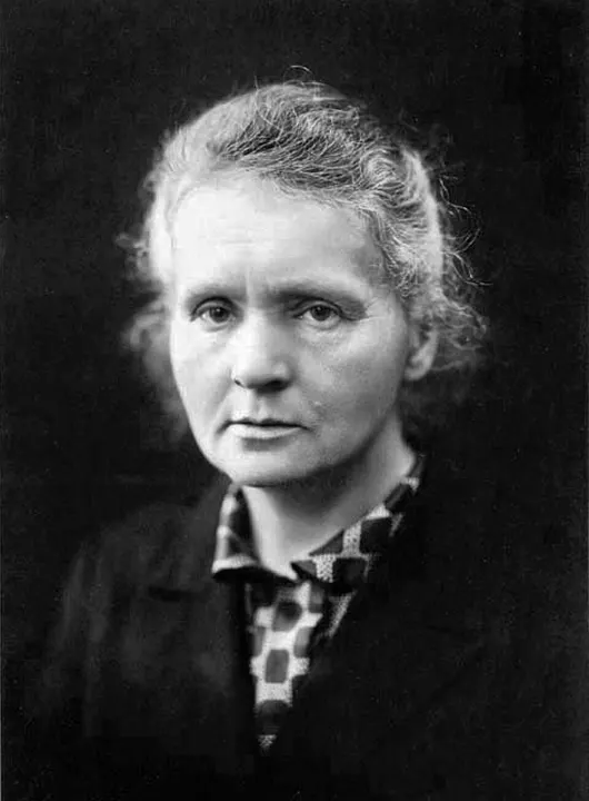 A black-and-white portrait of a woman in a dark dress with her hair pinned back.