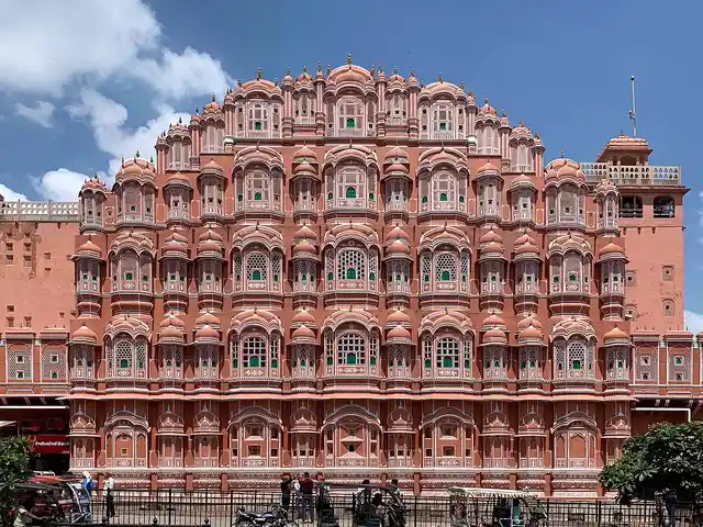 Pink sandstone facade covered with hundreds of small latticed windows
