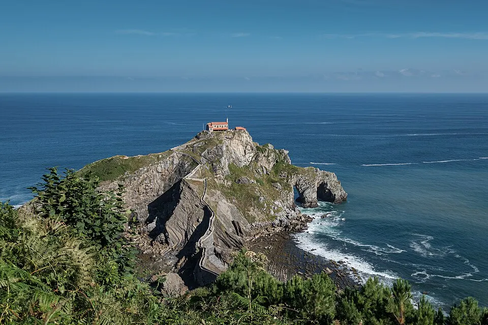 A small hermitage on a rocky islet joined to the coast by a stone path.