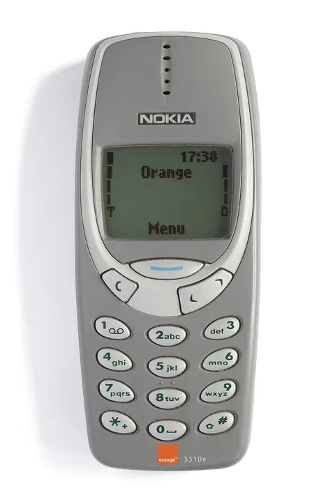 A small grey mobile phone with a keypad.
