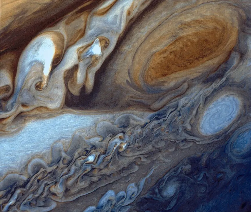 A giant swirling reddish oval storm in a banded atmosphere.