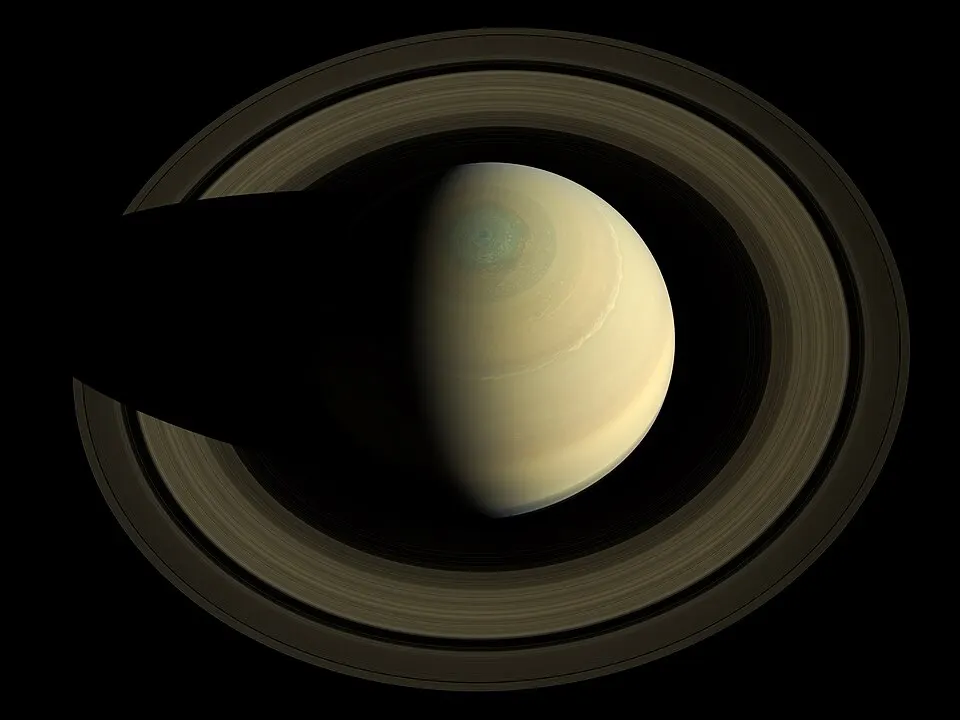 A golden banded globe circled by wide, bright rings.