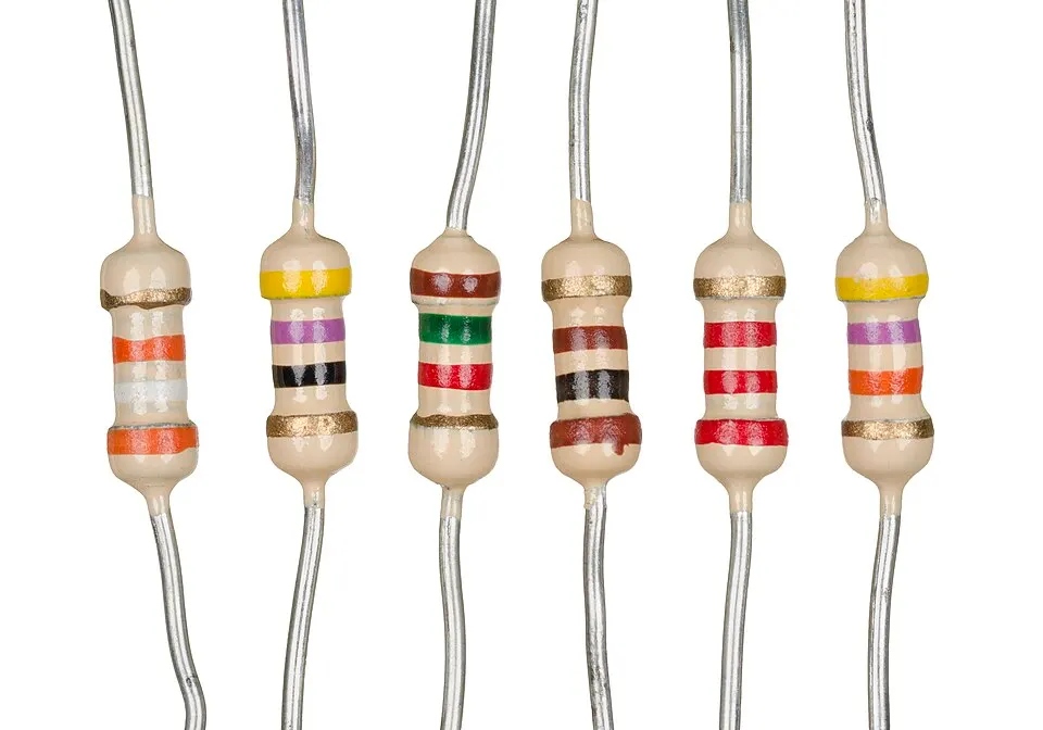 Six small cream-coloured electronic parts with coloured stripes and thin metal wires at each end.