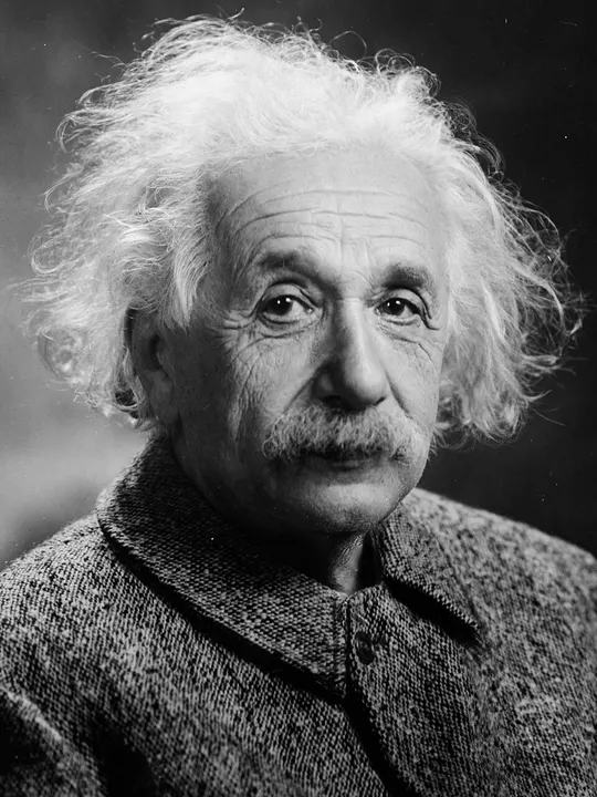 A black-and-white portrait of an older man with untidy white hair.
