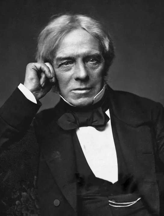 A portrait of a man with swept grey hair in a dark coat.