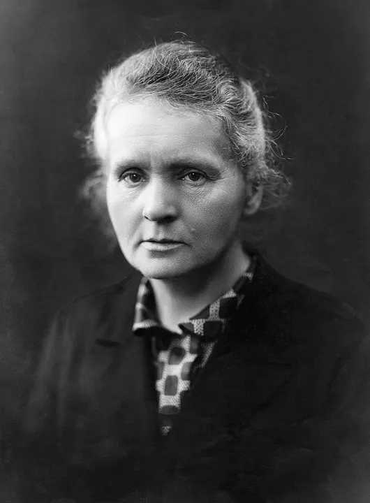 A black-and-white portrait of a woman in a dark dress.