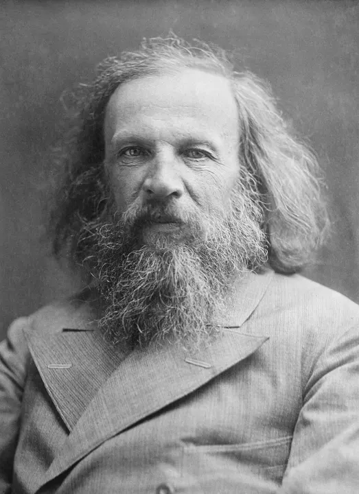 A portrait of an old man with a long beard and wild hair.