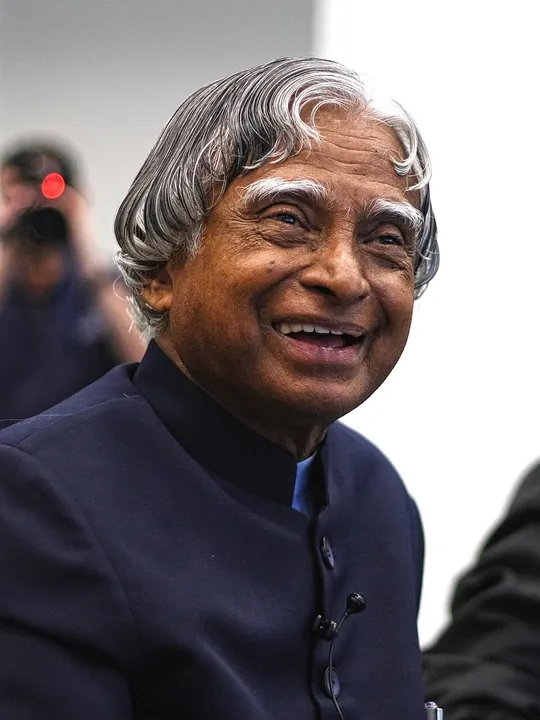 A smiling older man with silver hair.
