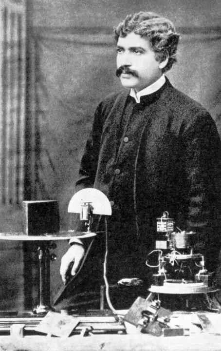 A black-and-white portrait of a man in formal clothes.