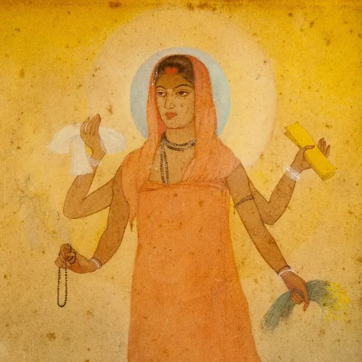 A painting of a four-armed woman in a saffron robe with a halo, holding a rosary, sheaves of grain, cloth and a yellow book.