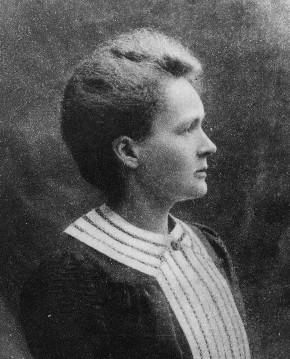 A black-and-white portrait of a woman in a dark dress.
